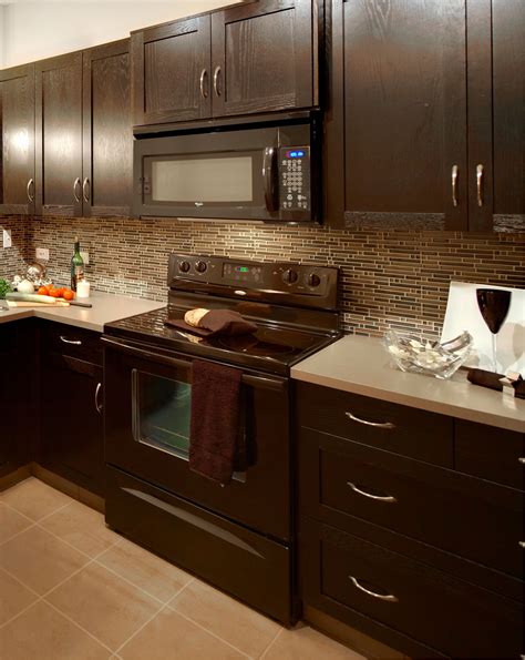 dark brown granite with light cabinets and stainless steel appliances|kitchens with brown cabinets.